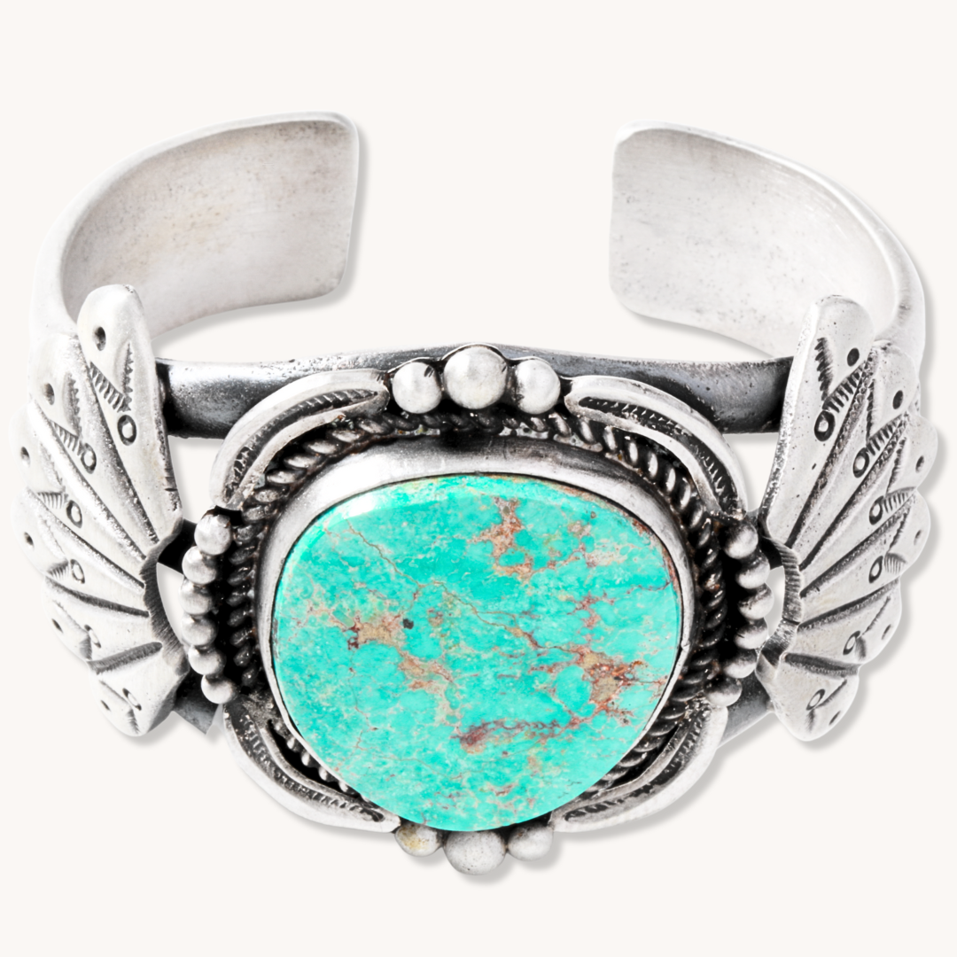 Statement Turquoise Cuff with Shield Accents, crafted from sterling silver, featuring a vibrant turquoise stone.