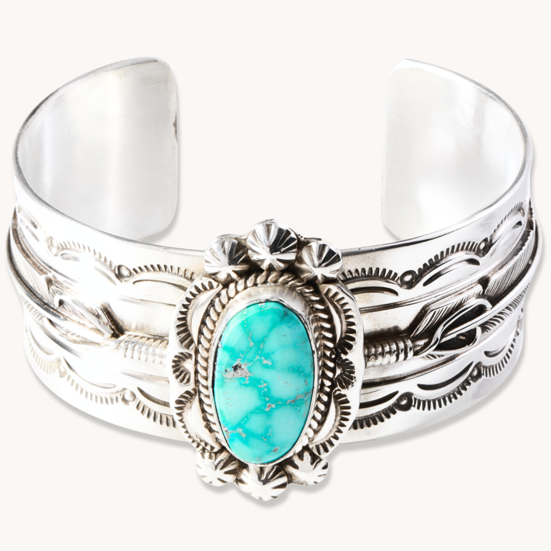 Hand-Stamped Turquoise Cuff Bracelet by T.Skies, made of sterling silver with a turquoise centerpiece.