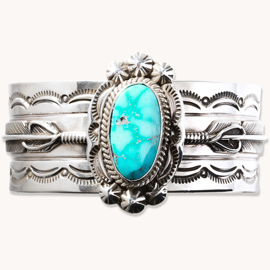Hand-Stamped Turquoise Cuff Bracelet by T.Skies, crafted from sterling silver with a central turquoise stone.