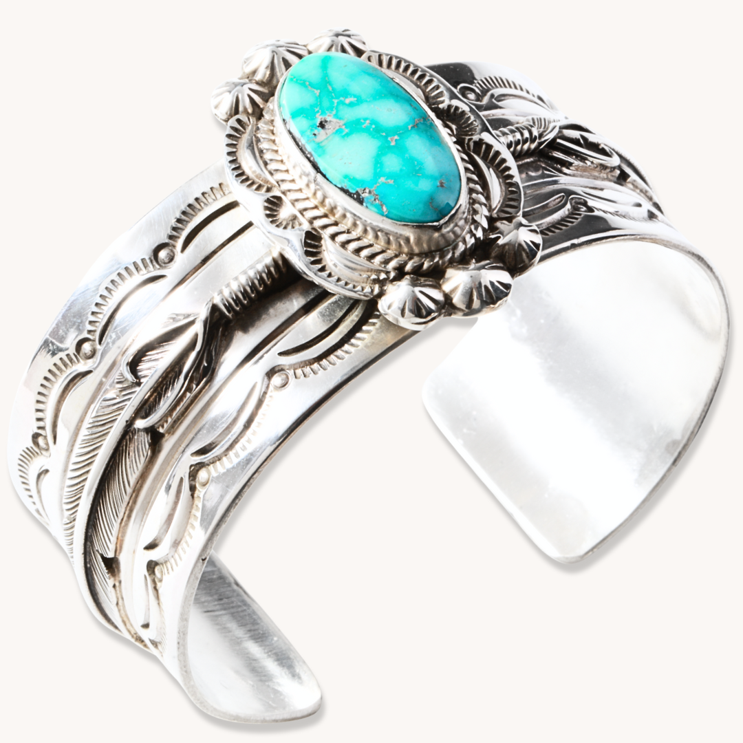 Hand-Stamped Turquoise Cuff Bracelet by T.Skies, made of sterling silver with intricate detailing and a turquoise stone.