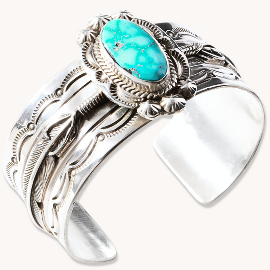 Hand-Stamped Turquoise Cuff Bracelet by T.Skies, made of sterling silver with intricate detailing and a turquoise stone.