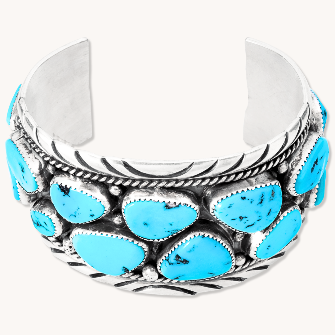 Turquoise Navajo Cluster Cuff Bracelet made of sterling silver, featuring multiple turquoise stones in a cluster design.