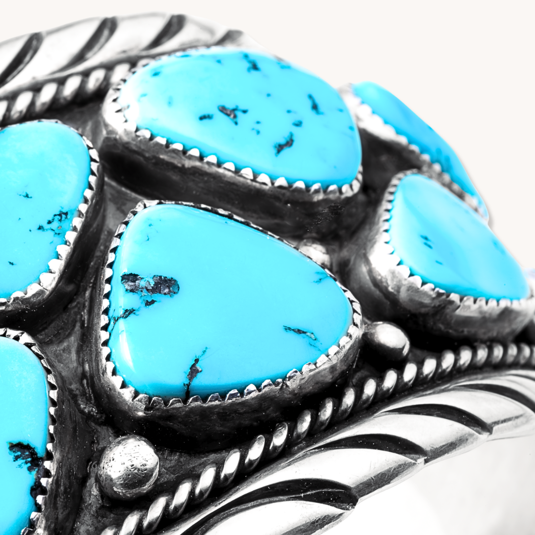 Turquoise Navajo Cluster Cuff Bracelet made of sterling silver featuring multiple turquoise stones in a cluster design.