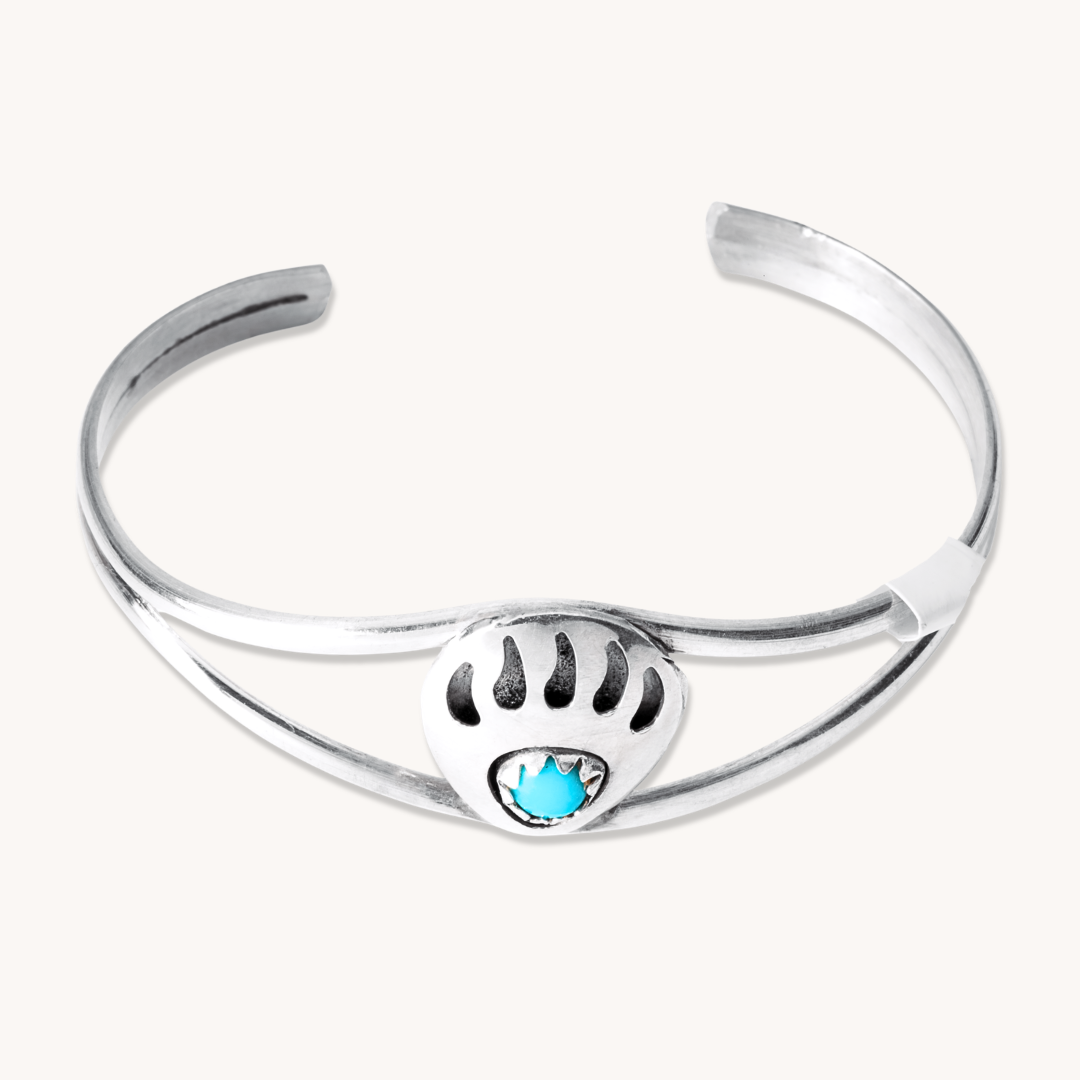 Turquoise Bear Paw Baby Bracelet by T.Skies, crafted from sterling silver with a turquoise stone centerpiece.