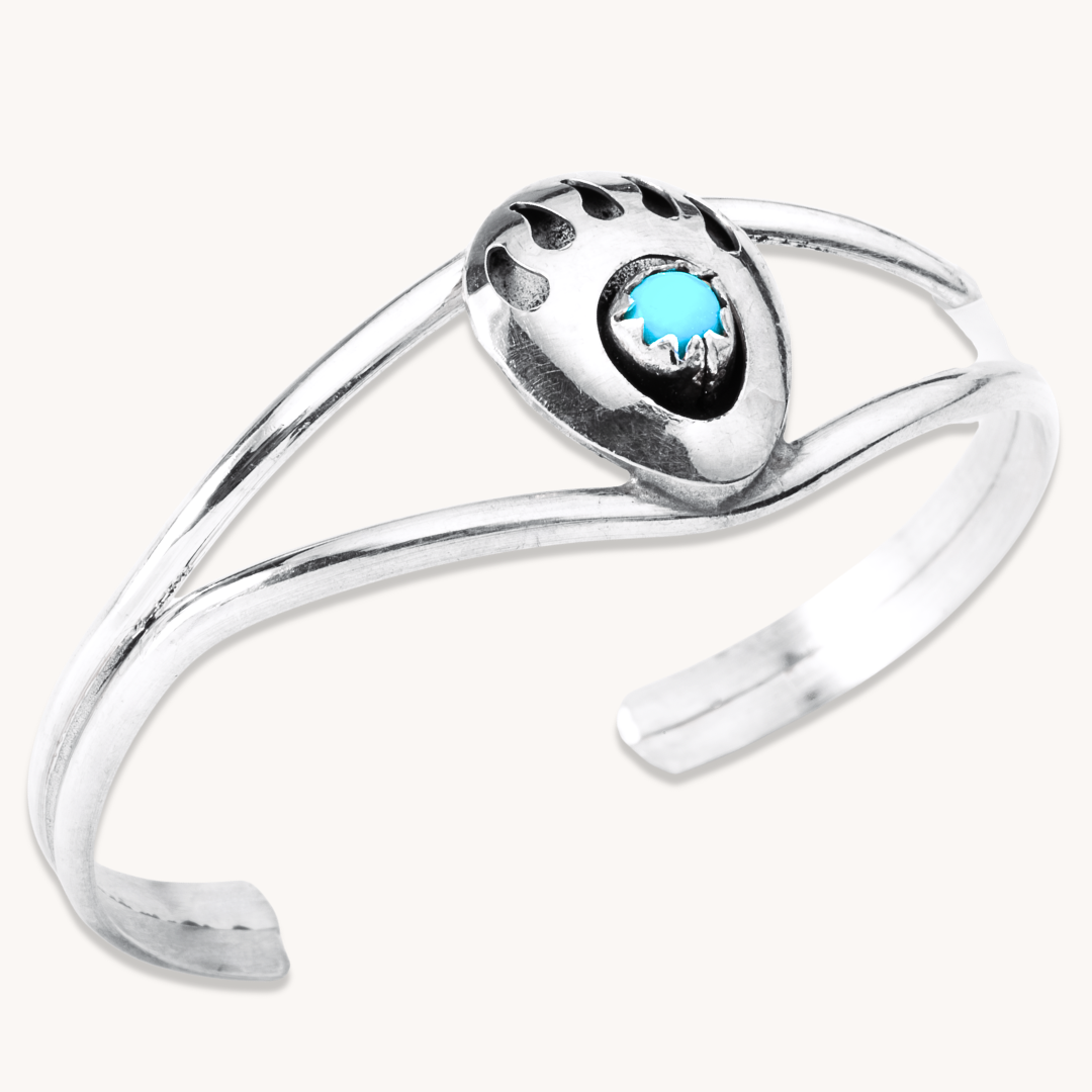 Turquoise Bear Paw Baby Bracelet by T.Skies, crafted from sterling silver with a turquoise stone centerpiece.