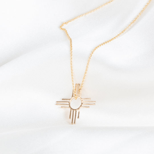 Enchantment: Petite Zia Pendant in sterling silver, featuring a unique Zia symbol on a delicate chain.