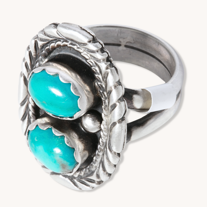 Two-Stone Turquoise Ring with Patterned Border, crafted from sterling silver by T.Skies, showcasing vibrant turquoise stones.