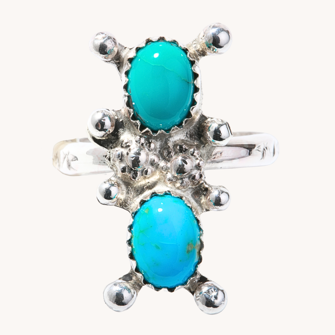 T.Skies Two-Stone Turquoise Ring featuring oval turquoise stones with silver bead accents, set in sterling silver.