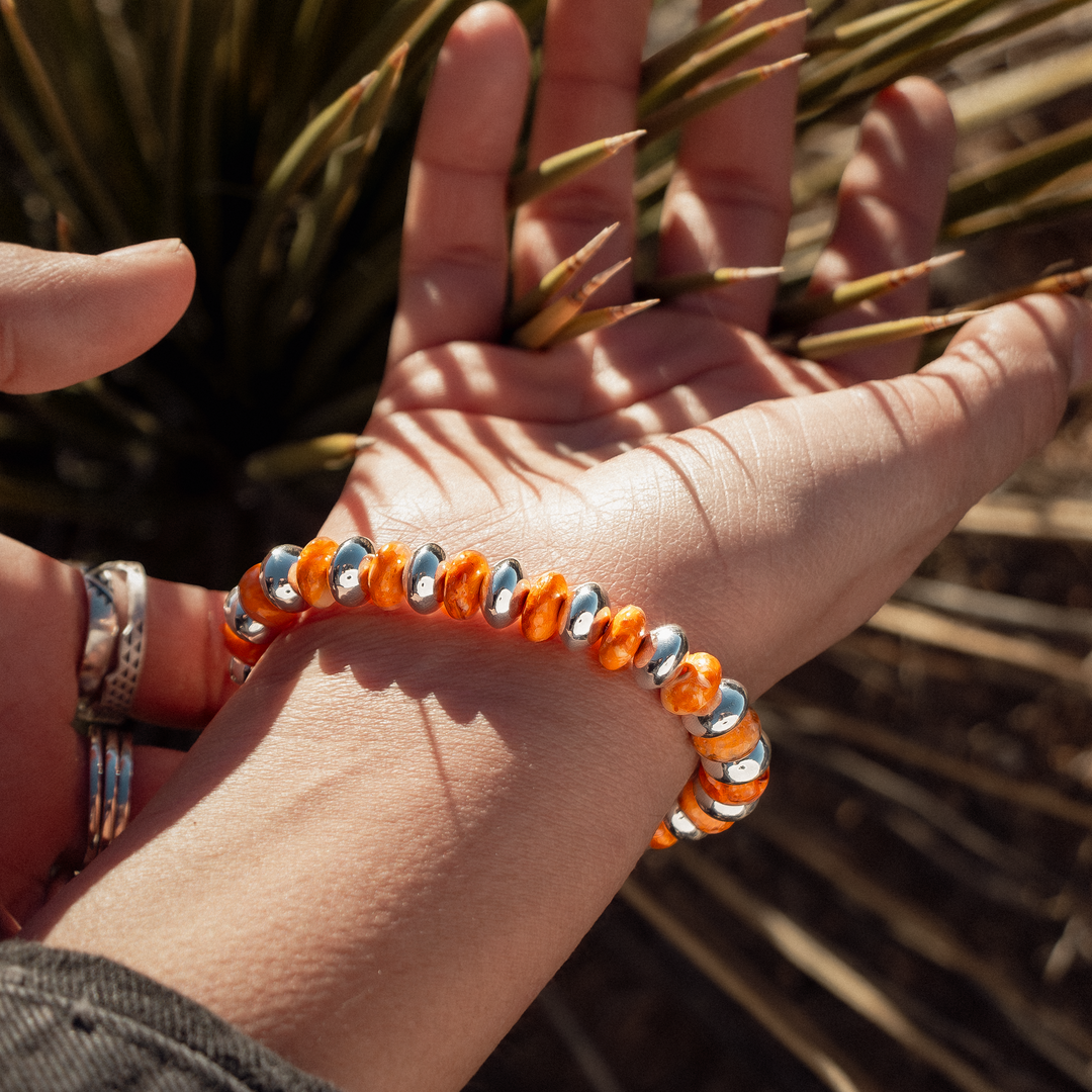 Bead Maiden: Spiny Oyster Stretch Bracelets featuring vibrant orange spiny oyster beads and sterling silver accents.