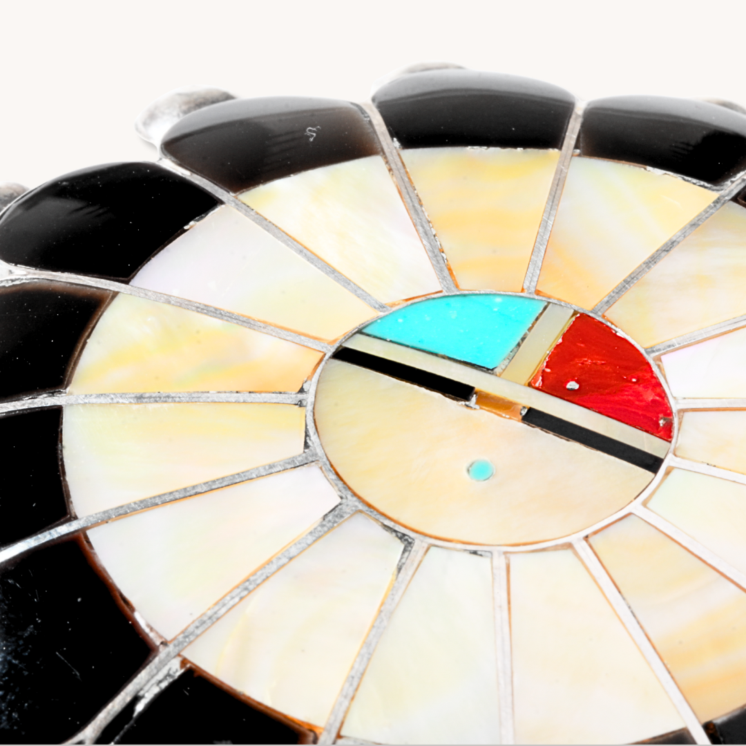 Zuni Sunface Pendant with Brooch Pin, crafted from sterling silver and colorful inlay materials, showcasing intricate design.