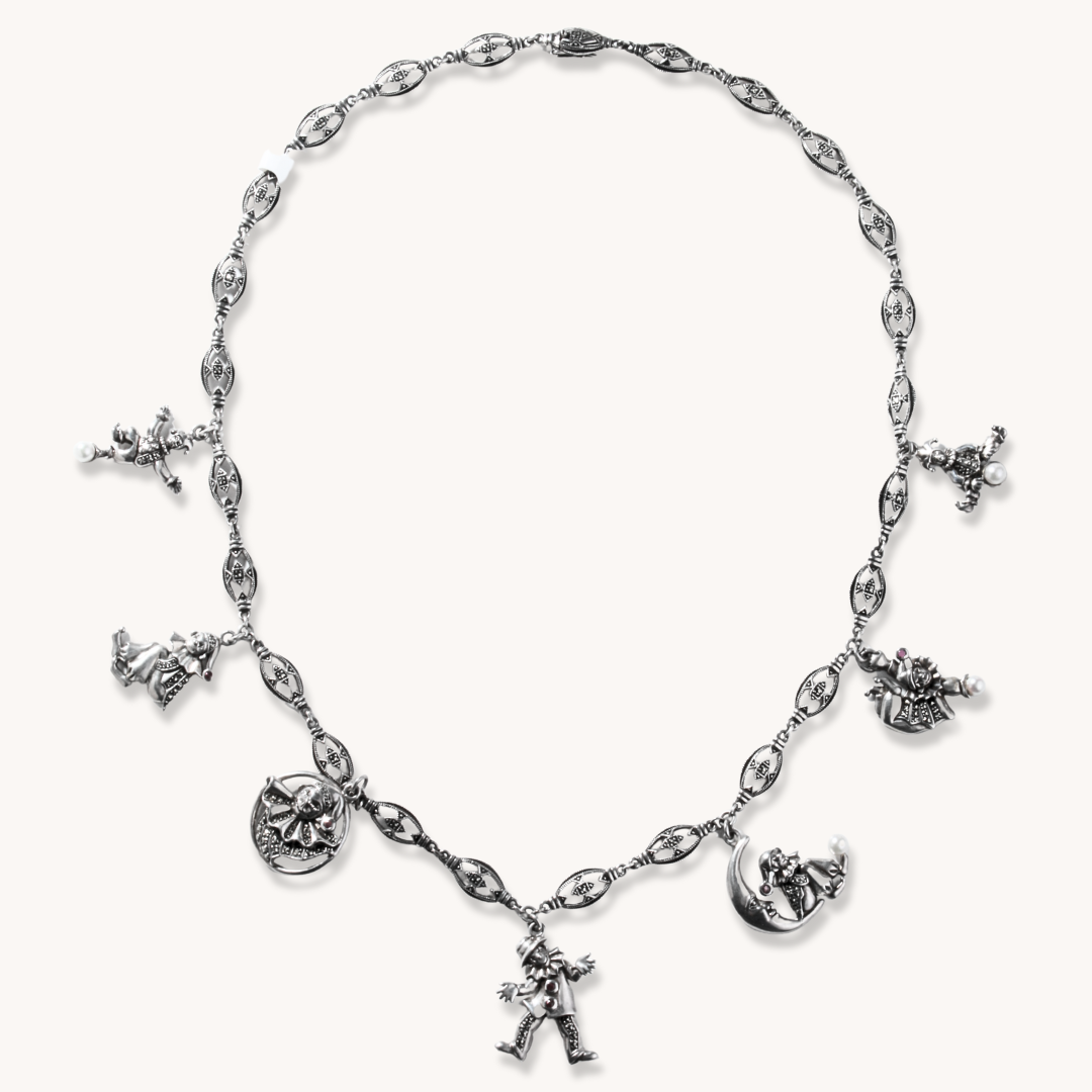 Harlequin Sterling Silver Charm Necklace featuring various playful charms and intricate detailing.