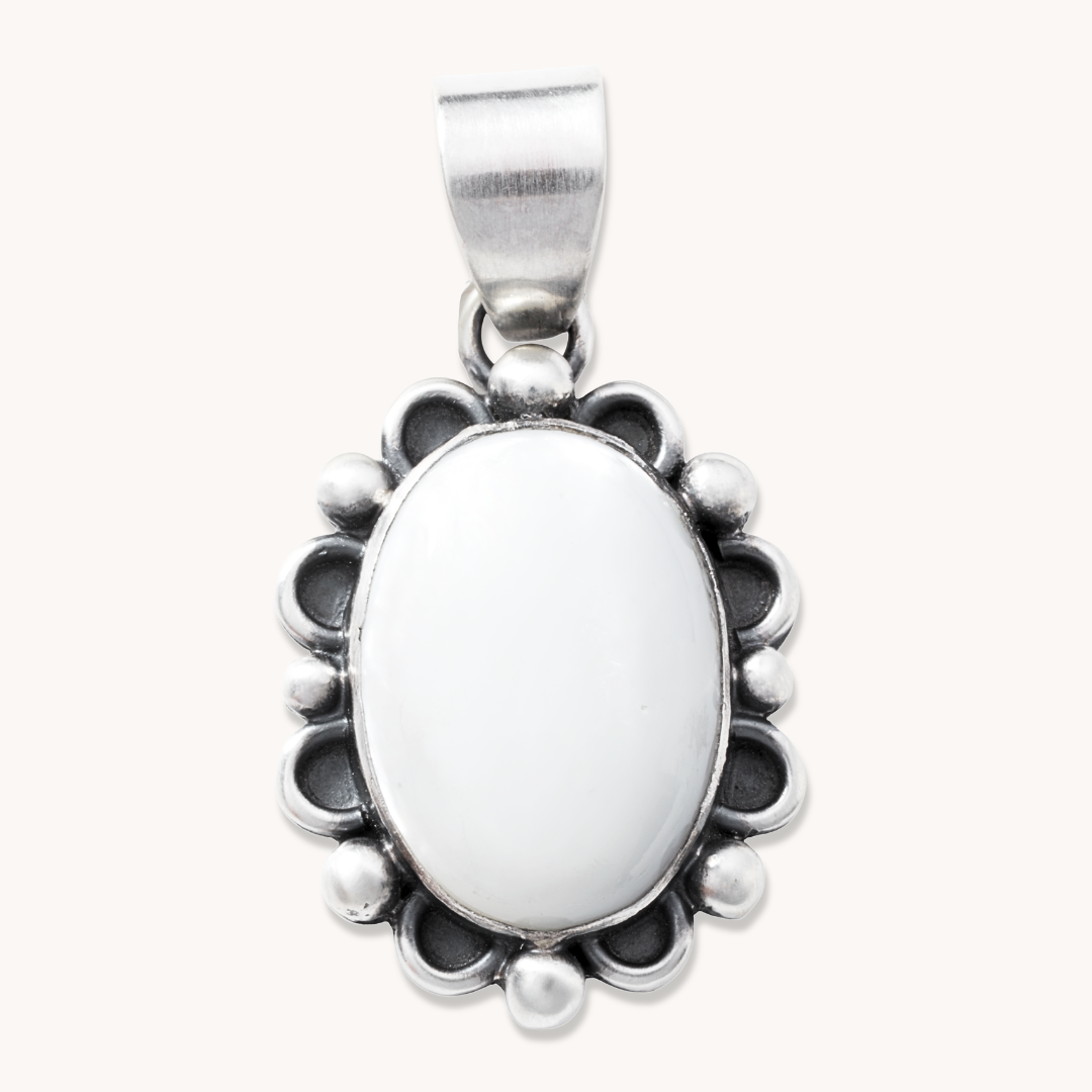 T.Skies delicate Mother of Pearl pendant with silver button accents, featuring an oval shape and intricate silver detailing.