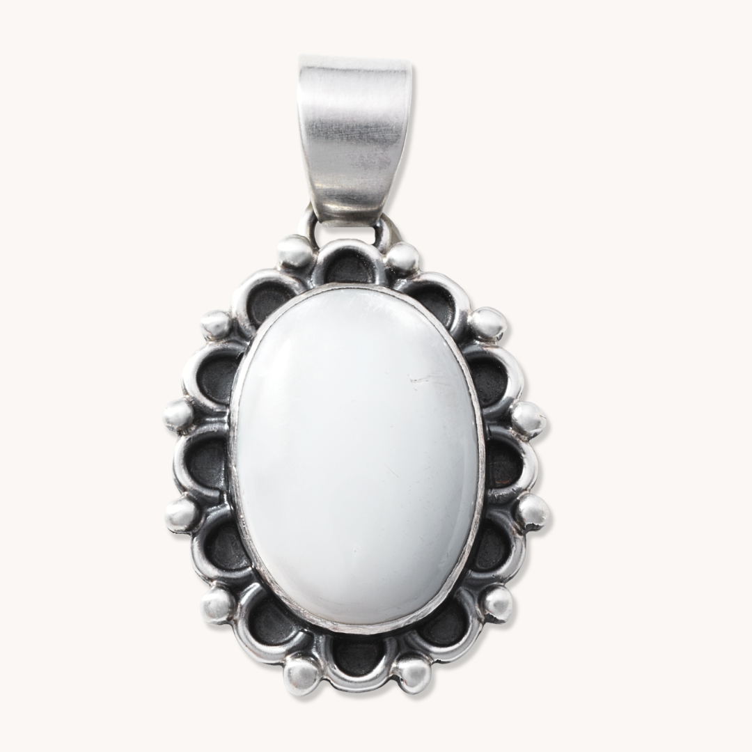 T.Skies delicate Mother of Pearl pendant featuring a silver button accent, set in a sterling silver frame.