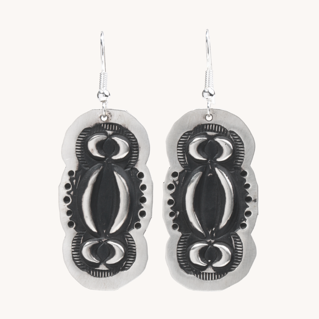 Navajo Silver Repousse Stamped Earrings by T.Skies, featuring intricate designs in sterling silver.