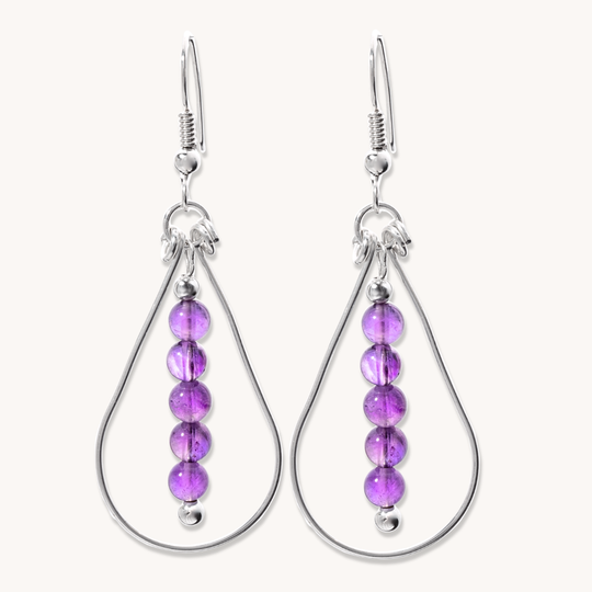 Bead Maiden: Wrapped Intention Earrings in sterling silver featuring five purple beads in a teardrop design.