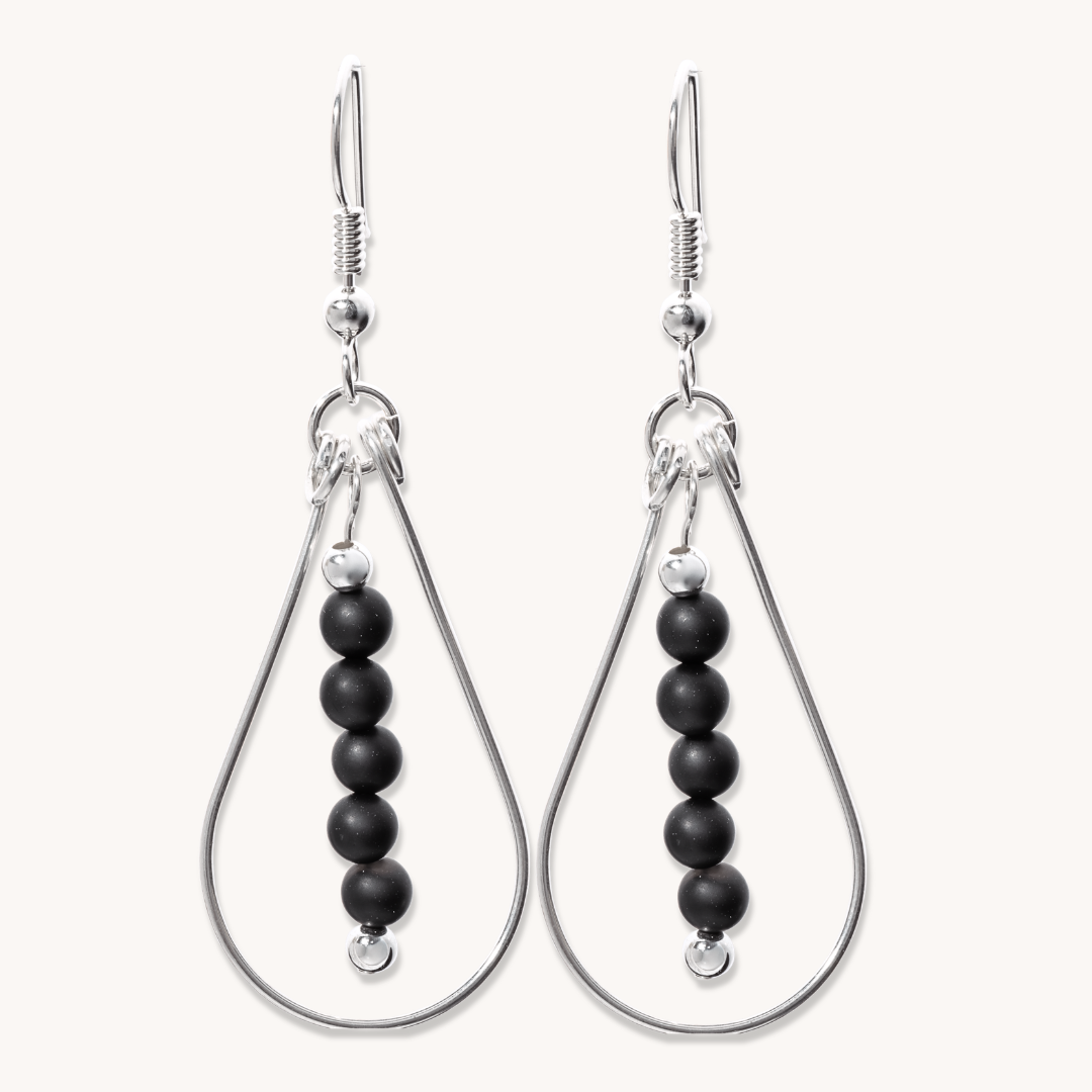 Bead Maiden: Wrapped Intention Earrings, sterling silver with black beads, showcasing a teardrop design.