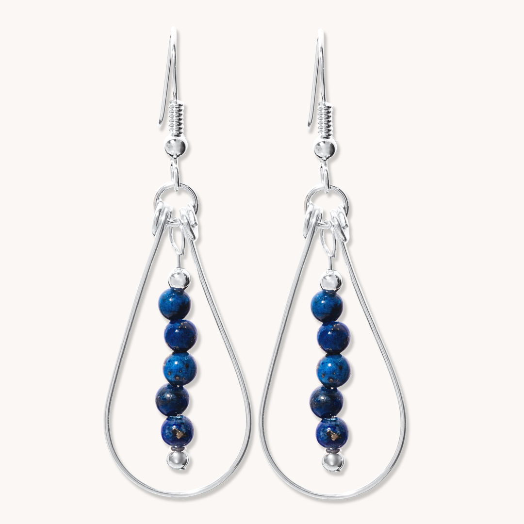 Bead Maiden: Wrapped Intention Earrings made of sterling silver with blue beads, featuring a teardrop design.