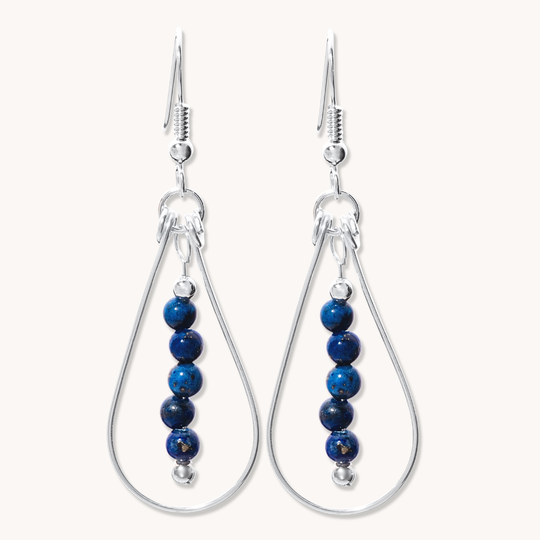 Bead Maiden: Wrapped Intention Earrings made of sterling silver with blue beads, featuring a teardrop design.
