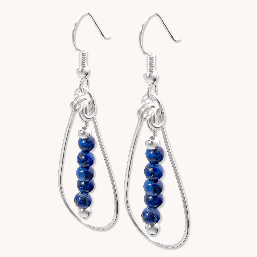 Bead Maiden: Wrapped Intention Earrings made of sterling silver featuring blue beads arranged in a teardrop design.