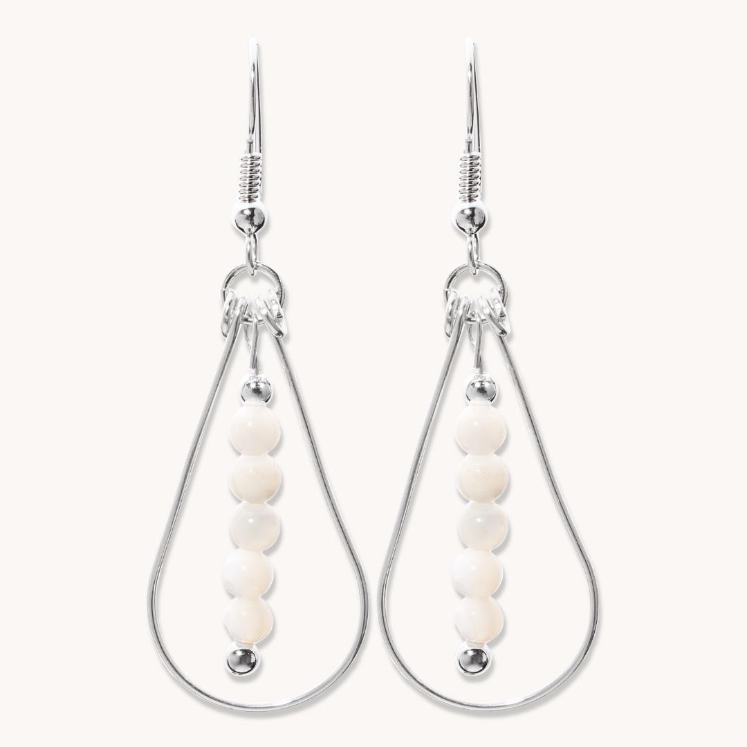 Bead Maiden: Wrapped Intention Earrings made of sterling silver with white beads, showcasing a teardrop design.