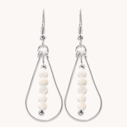 Bead Maiden: Wrapped Intention Earrings made of sterling silver with white beads, showcasing a teardrop design.
