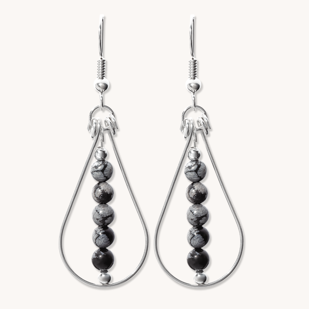 Bead Maiden: Wrapped Intention Earrings made of sterling silver with black and gray beads, showcasing a teardrop design.