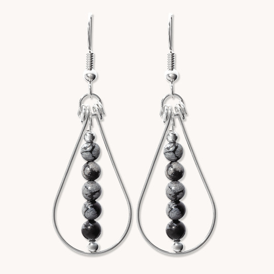 Bead Maiden: Wrapped Intention Earrings made of sterling silver with black and gray beads, showcasing a teardrop design.