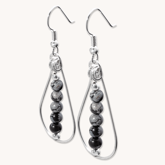 Bead Maiden: Wrapped Intention Earrings made of sterling silver with black and gray beads, showcasing a teardrop design.
