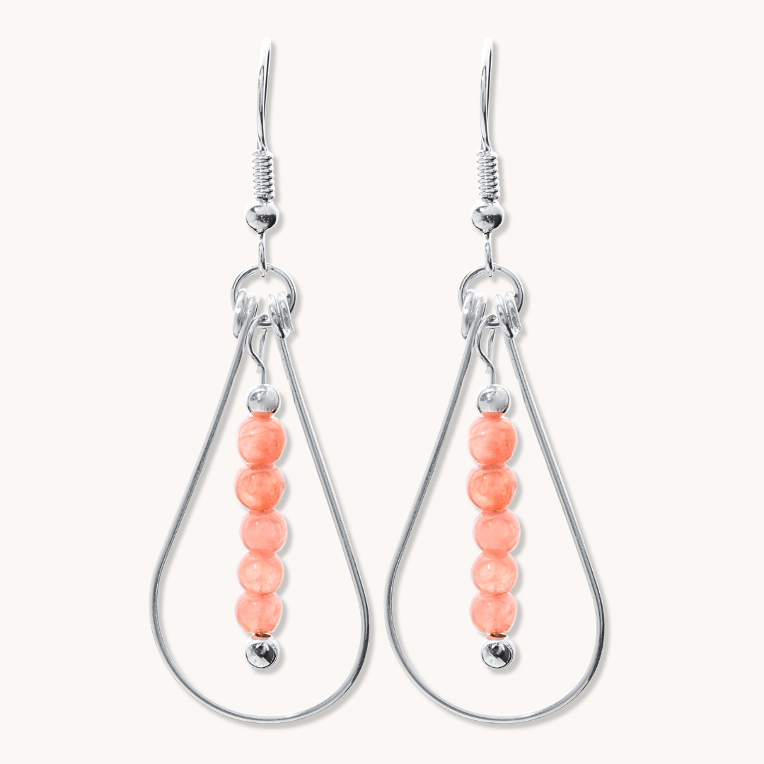 Bead Maiden: Wrapped Intention Earrings made of sterling silver with coral beads, featuring a teardrop design.