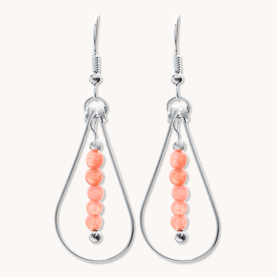 Bead Maiden: Wrapped Intention Earrings made of sterling silver with coral beads, featuring a teardrop design.