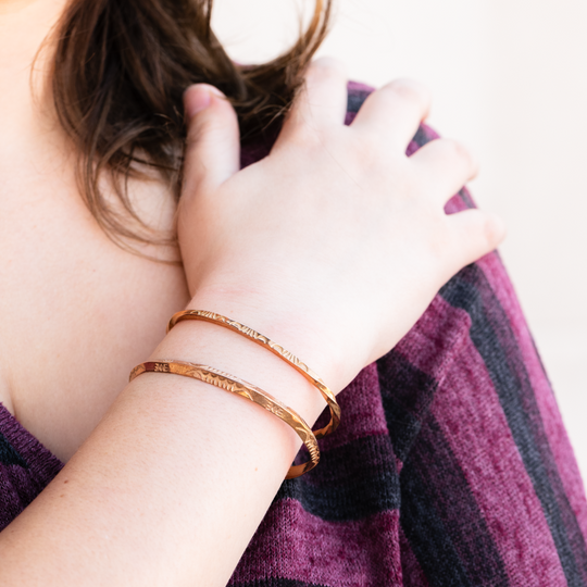 Stamp Dancer: Sage Twist Stacker Bracelet, handcrafted sterling silver, worn on a wrist with a patterned top.