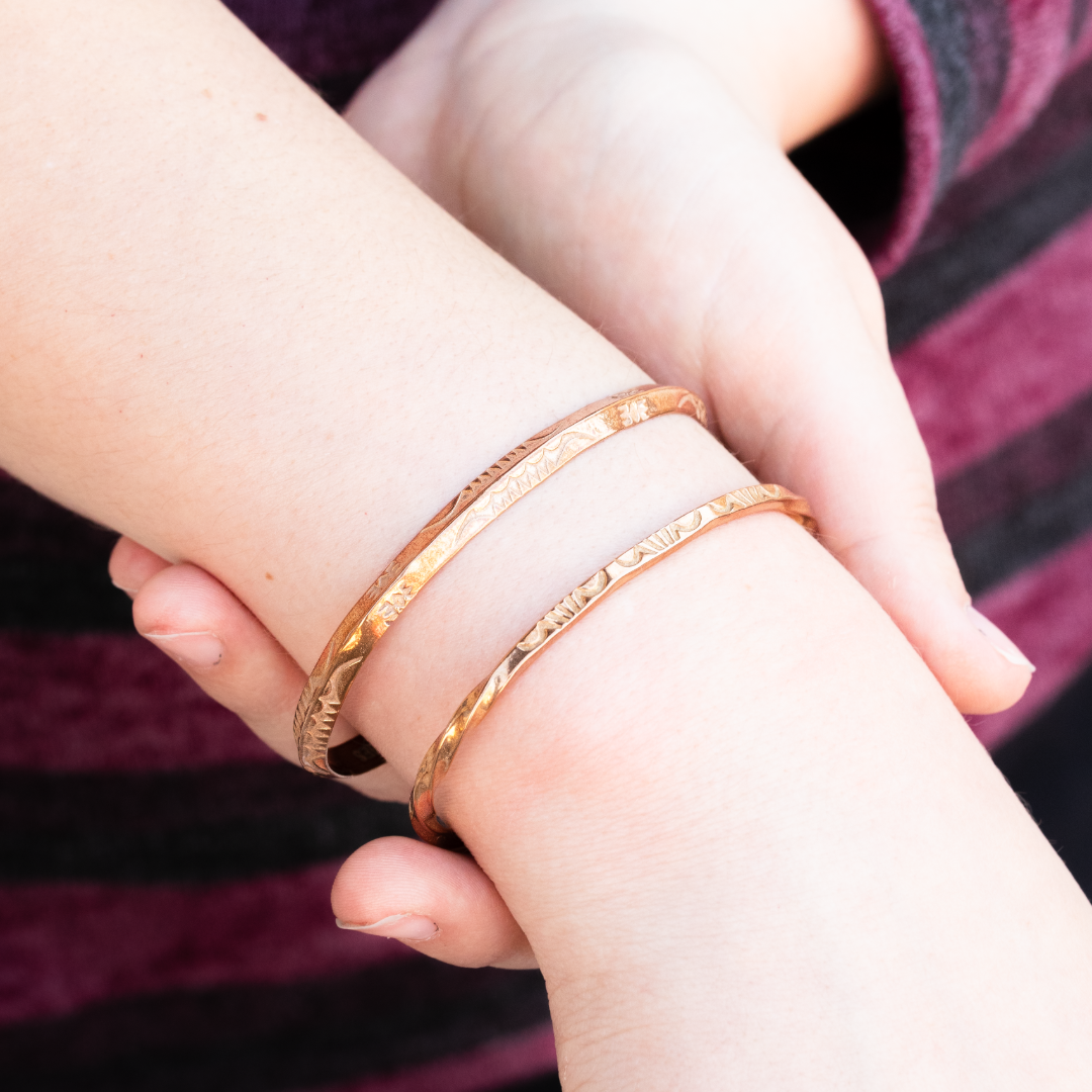 Stamp Dancer: Sage Twist Stacker Bracelet, sterling silver, featuring intricate designs, worn on a wrist.