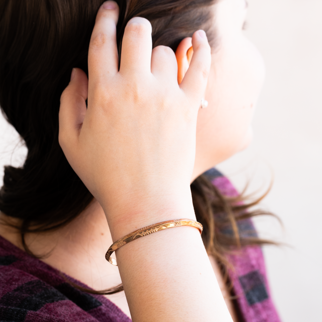 Sagebrush Stacker Bracelet by T.Skies, made of sterling silver, worn on a woman's wrist with a hand in her hair.