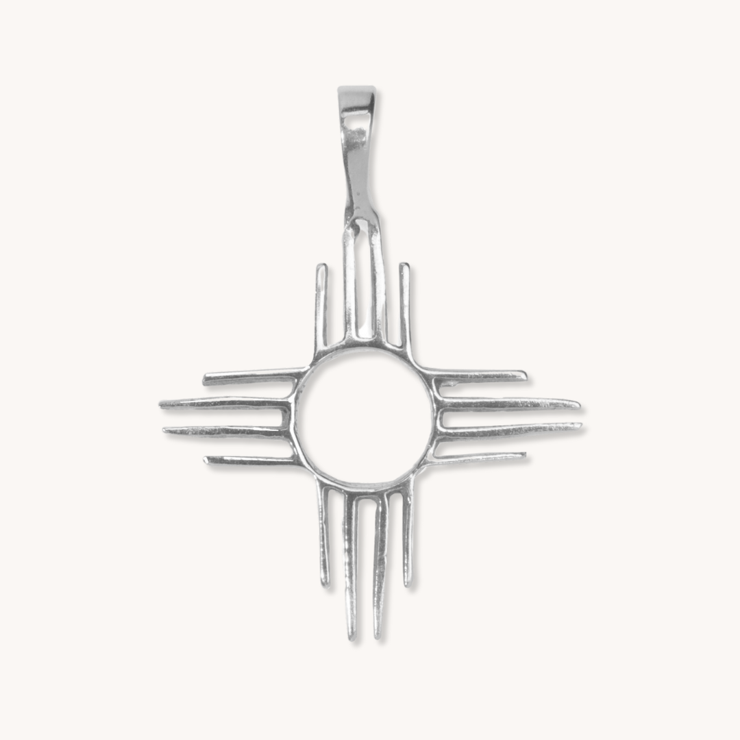 Enchantment: Zia Pendant crafted from sterling silver, featuring a circular center and radiating lines, inspired by Native American design.
