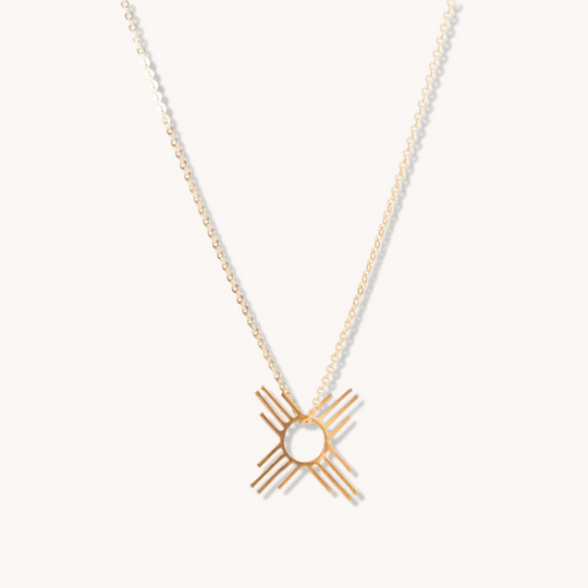 Enchantment: Petite Zia Pendant in sterling silver featuring a geometric sun design on a delicate chain.