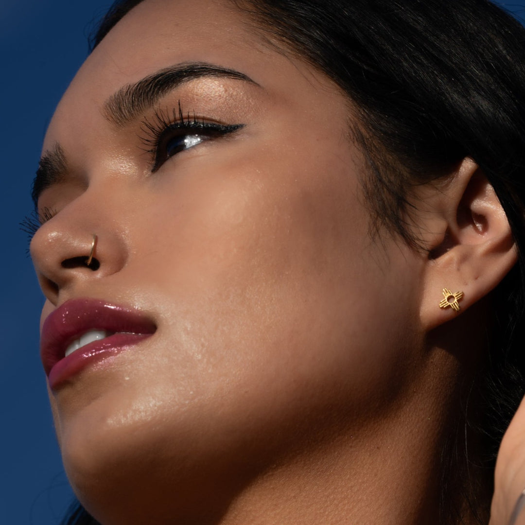 T.Skies Enchantment Mini Zia Stud Earrings in sterling silver, worn by a model with a natural makeup look.