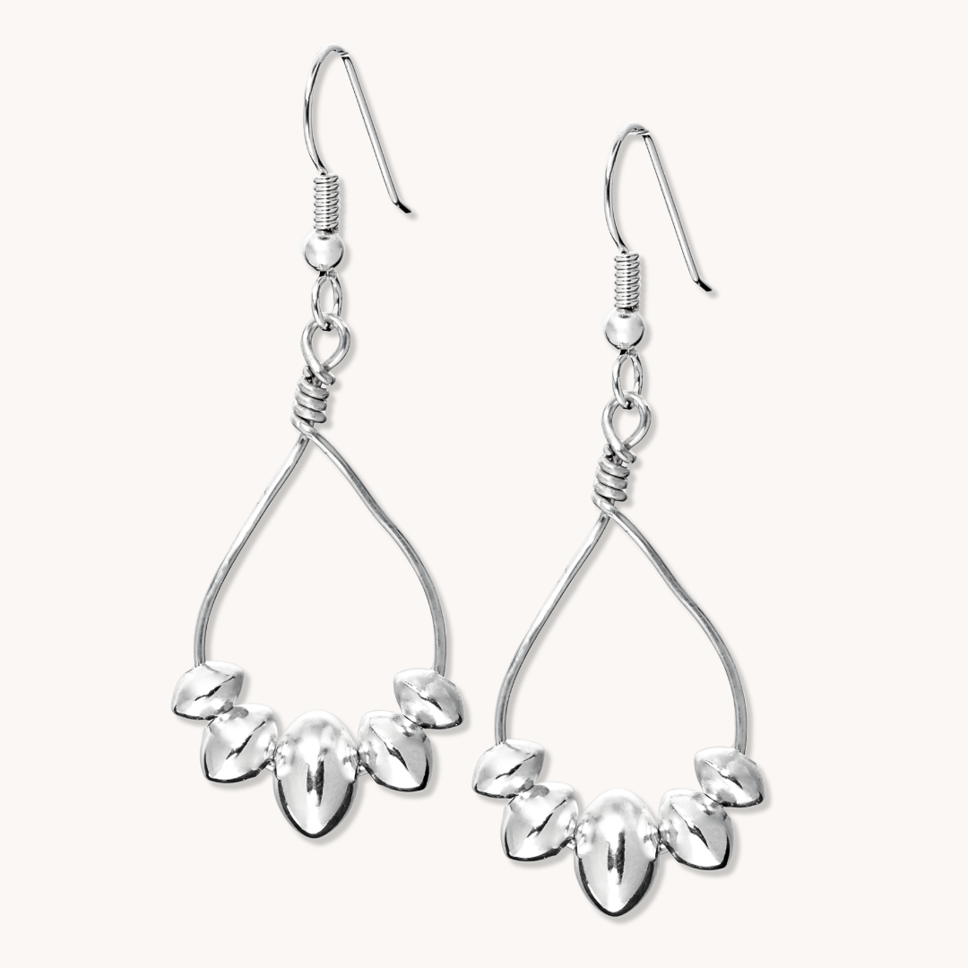 Desert Blossom: Lotus Flower Earrings made of sterling silver, featuring a delicate floral design with teardrop shapes.