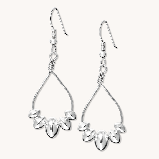 Desert Blossom: Lotus Flower Earrings made of sterling silver, featuring a delicate floral design with teardrop shapes.