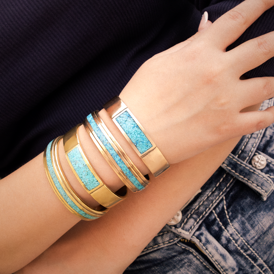 Radiante: Turquoise Vista Bracelet, featuring turquoise inlay and sterling silver, worn on a hand against denim.